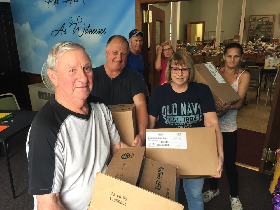 hunger team carrying boxes of food
